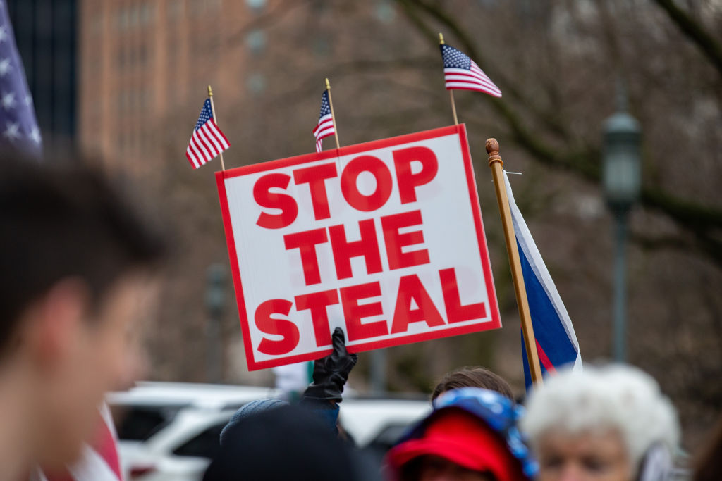A protester holds a “stop the steal” placard during a pro-