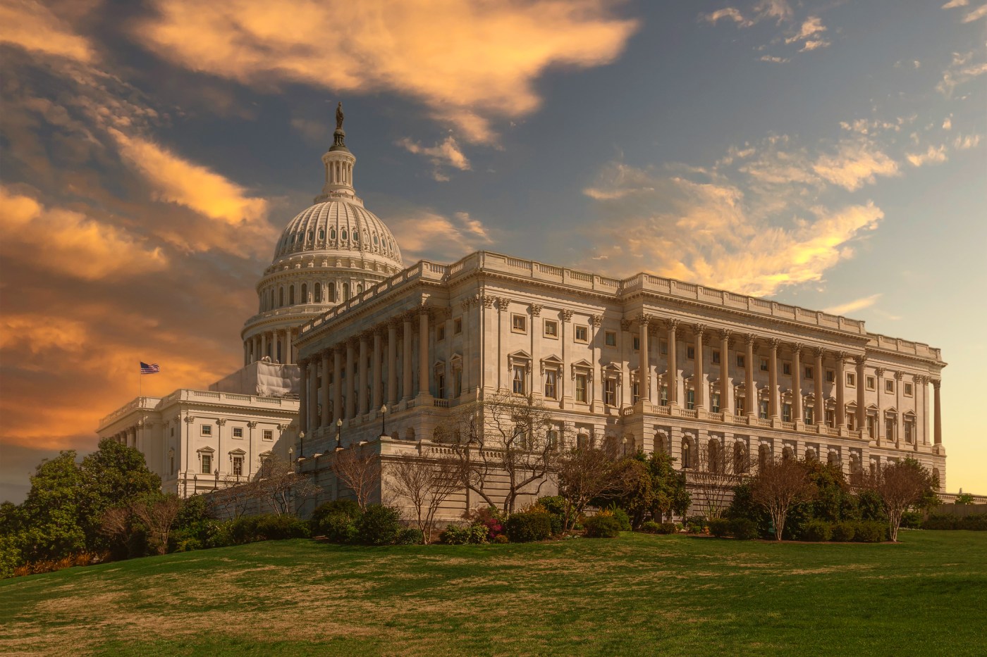 South Wing (the House of Representatives wing) of the US Capitol Building with Orange, Yellow and Blue Sunset Sky, Washington DC, USA.