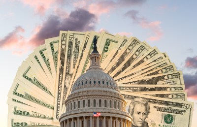 Flag flies in front of Capitol in DC with cash behind the dome as concept for stimulus virus payment