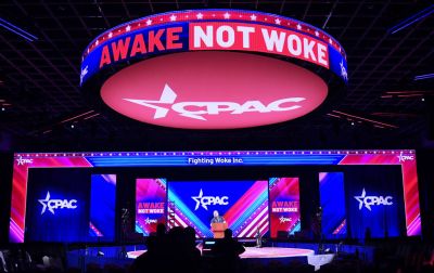 Workers prepare the stage for the 2022 meeting of the