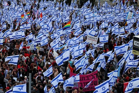 Protesters gather with national flags outside Israel's parliament in Jerusalem amid ongoing demonstrations against the government's controversial push to overhaul the justice system, on March 27, 2023. (Photo by AHMAD GHARABLI/AFP via Getty Images)