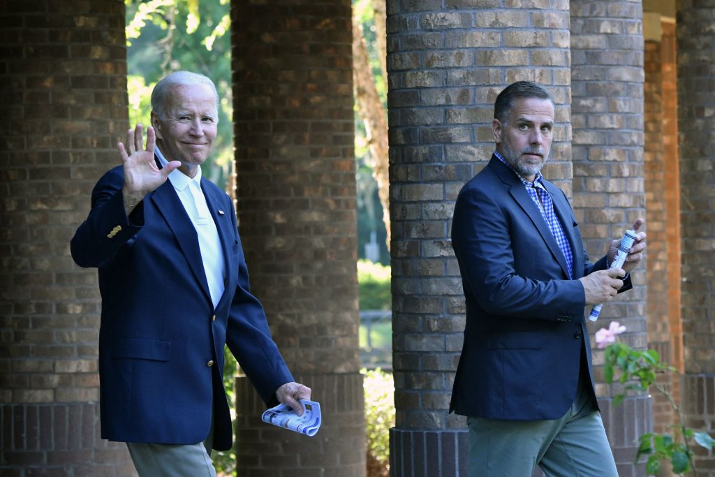 President Joe Biden waves alongside his son Hunter Biden in August 2022. (Photo by NICHOLAS KAMM/AFP via Getty Images)