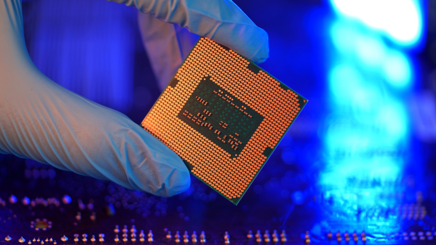 Close-up gloved hands holding detail microchip