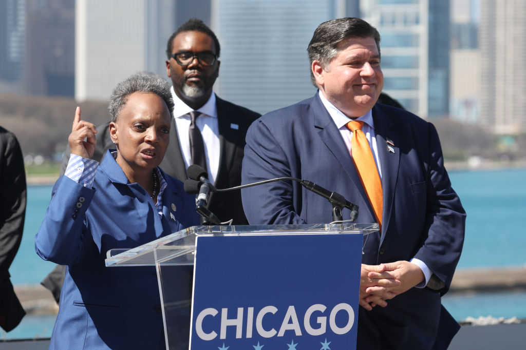 Mayor Lori Lightfoot (left) accompanied by Mayor-elect Brandon Johnson (center) and Illinois Gov. J.B. Pritzker during an event to announce Chicago as the host city for the 2024 Democratic National Convention on April 12, 2023 in Chicago, Illinois. (Photo by Scott Olson/Getty Images)