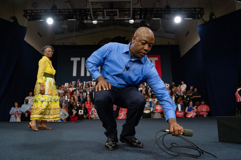 Sen. Tim Scott moves a microphone as his mother, Frances Scott, looks on after he announced his run for the 2024 Republican presidential nomination on May 22, 2023 in North Charleston, South Carolina. (Photo by Allison Joyce/Getty Images)
