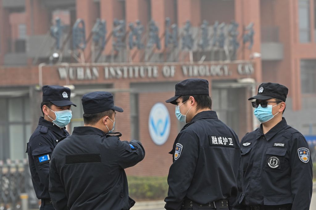 Security personnel stand guard outside the Wuhan Institute of Virology. (Photo by HECTOR RETAMAL/AFP via Getty Images)