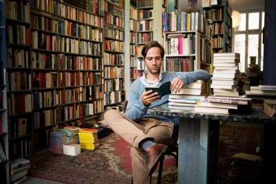 Man reading books in bookstore