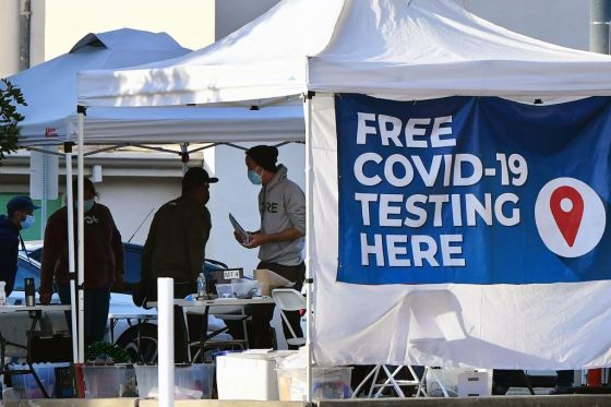People wait in line for a free COVID-19 test in Los Angeles, California. (Photo by FREDERIC J. BROWN/AFP via Getty Images)