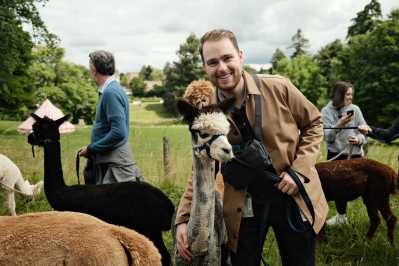 Alex with an alpaca in the Cotswolds, England. (Photo courtesy of Alex Demas)