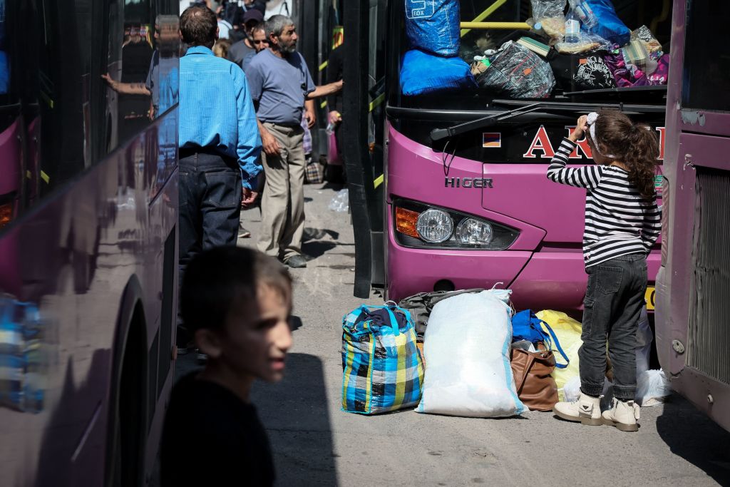 Armenian refugees wait in a square of Goris city centre on September 29. (Photo by ALAIN JOCARD/AFP via Getty Images)