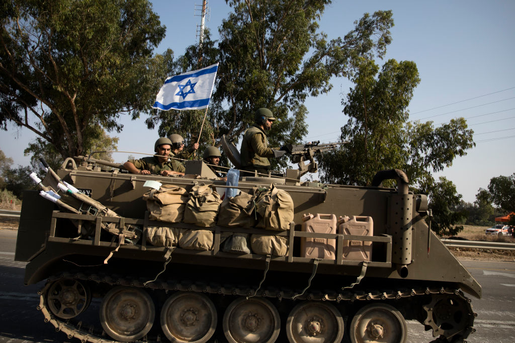 Israeli soldiers in an armoured personnel carrier head towards the southern border with the Gaza Strip on October 8, 2023 in Sderot, Israel. (Footage by Amir Levy/Getty Images)