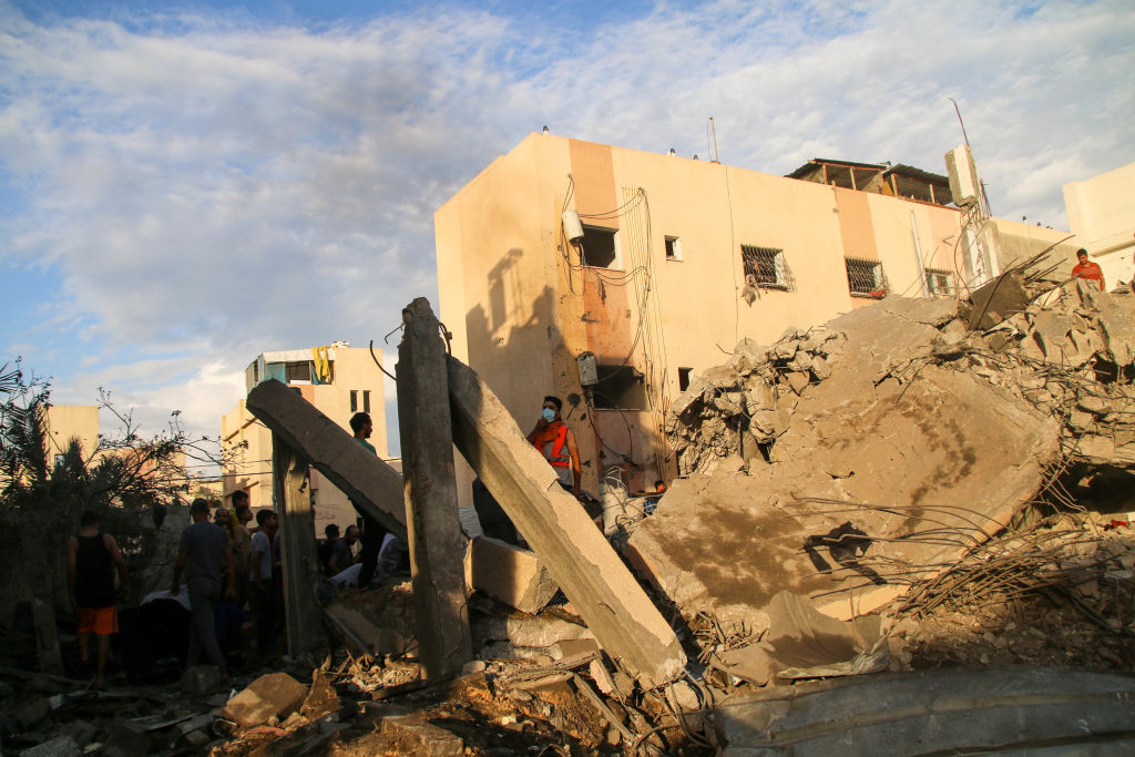 Palestinian emergency services and local citizens search for victims in buildings destroyed during Israeli raids in the southern Gaza Strip on October 17, 2023 in Khan Yunis, Gaza. (Photo by Ahmad Hasaballah/Getty Images)