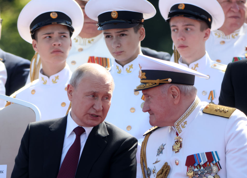 Russian President Vladimir Putin talks to the Russian Navy's Commander-in-Chief Nikolai Yevmenov during the annual Navy Day Parade on July 30, 2023, in Saint Petersburg, Russia. (Photo by Contributor/Getty Images)