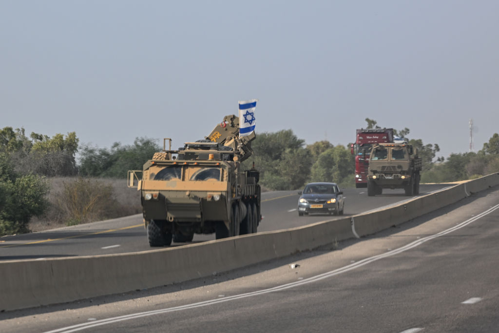 IDF vehicles drive on a road on October 31, 2023 in Southern Israel. (Photo by Alexi J. Rosenfeld/Getty Images)