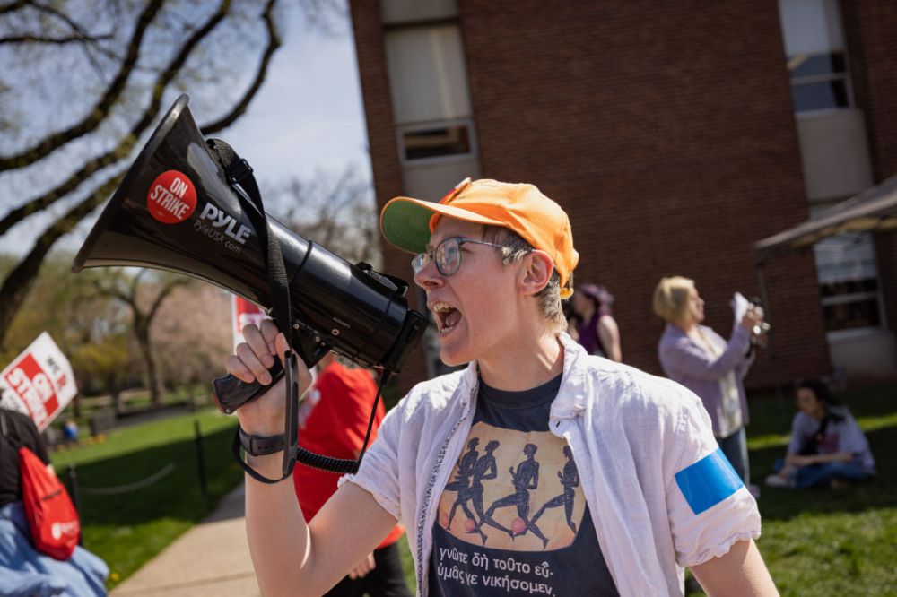 A protester with a bullhorn leads chants with Rutgers