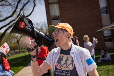 A protester with a bullhorn leads chants with Rutgers