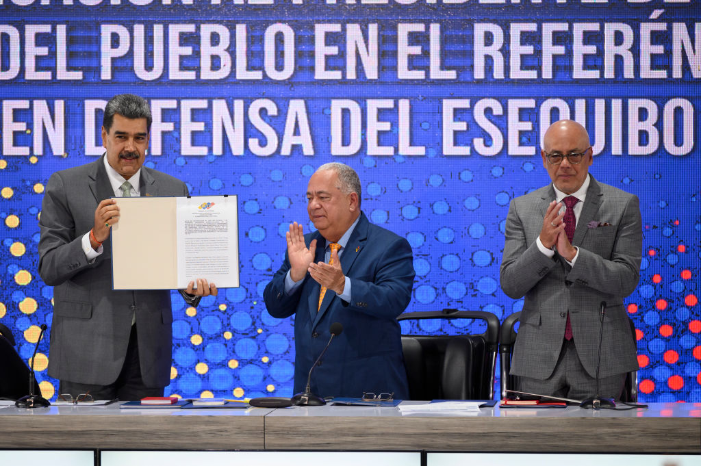 Venezuelan President Nicolás Maduro shows off the referendum notification act during a press conference in Caracas on December 4, 2023—one day after Venezuelans voted in a referendum on the country's border with Guyana. (Photo by Gaby Oraa/Getty Images)