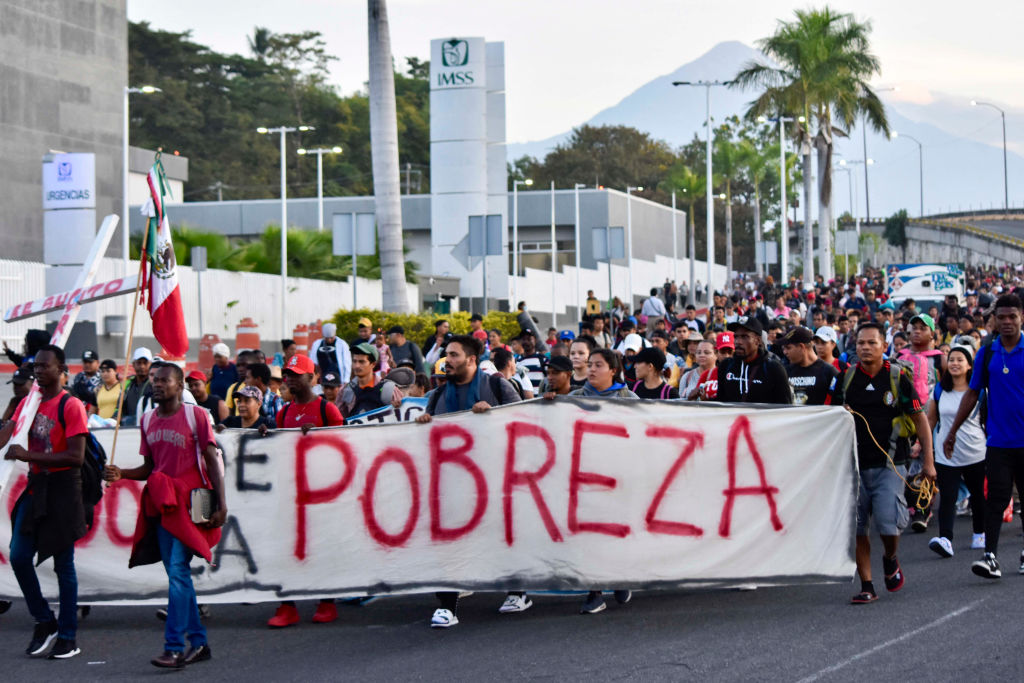 Migrants take part in a caravan towards the border with the United States in Tapachula, Chiapas State, Mexico, on December 24, 2023. (Photo by STR/AFP via Getty Images)