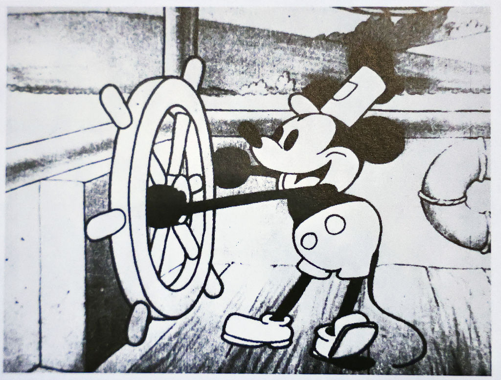 A still image from Disney's 'Steamboat Willie' that was the debut of Mickey Mouse is seen in a book on January 3, 2024 in Glendale, California. (Photo illustration by Mario Tama/Getty Images)