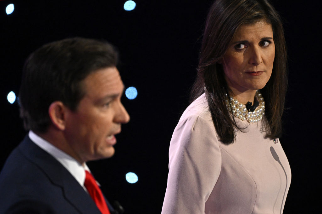 Florida Gov. Ron DeSantis speaks as former U.S. Ambassador to the U.N. Nikki Haley looks on during the fifth Republican presidential primary debate at Drake University in Des Moines, Iowa, on January 10, 2024. (Photo by Jim WATSON / AFP) (Photo by JIM WATSON/AFP via Getty Images)