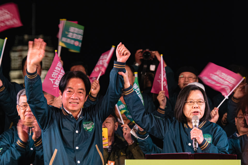 Taiwan's President Tsai Ing-wen joins hands with the presidential candidate of ruling Democratic Progressive Party (DPP) Lai Ching-te during a campaign rally on January 11, 2024 in Taipei, Taiwan. (Photo by Sawayasu Tsuji/Getty Images)