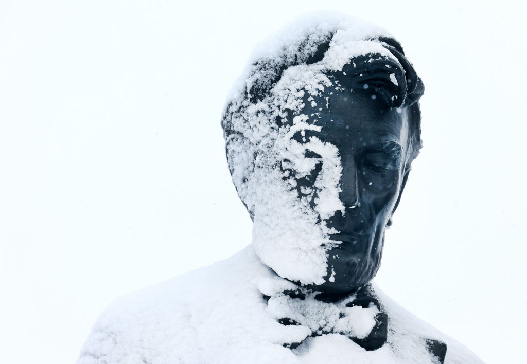 Snow covers half the face of former President Abraham Lincoln's statue at the Iowa State Capitol building on January 9, 2024, in Des Moines, Iowa. (Photo by Joe Raedle/Getty Images)