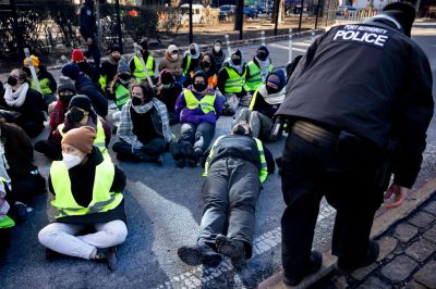 Arrested and handcuffed pro-Palestine demonstrators wait for