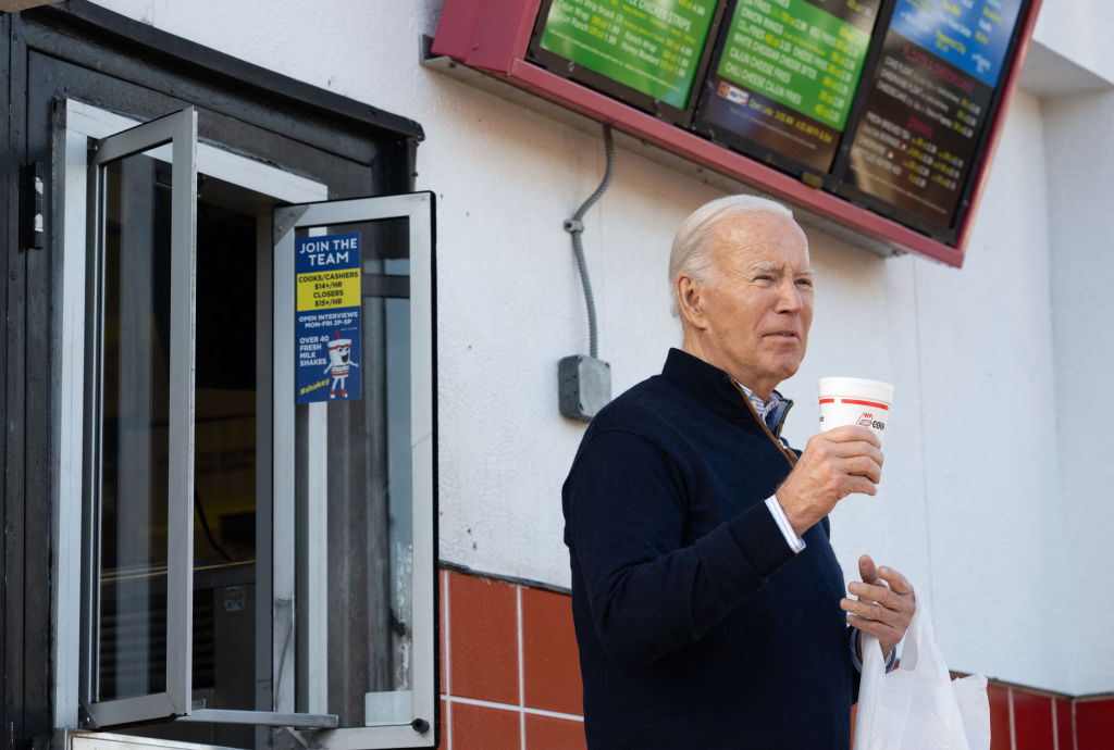 President Joe Biden holds a milkshake during a quick stop at Cook Out, a restaurant in Raleigh, North Carolina, following an event to promote his economic agenda on January 18, 2024. (Photo by Saul Loeb/AFP/Getty Images)