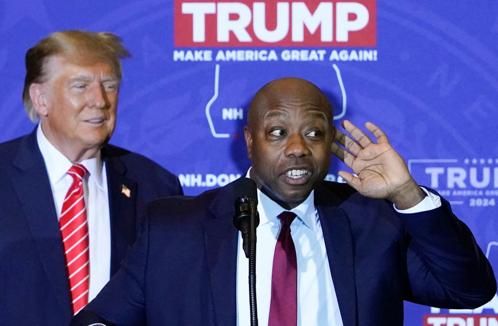 Sen. Tim Scott speaks as  former President Donald Trump listens during a campaign event in Concord, New Hampshire, on January 19, 2024. (Photo by Timothy A. Clary/AFP/Getty Images)