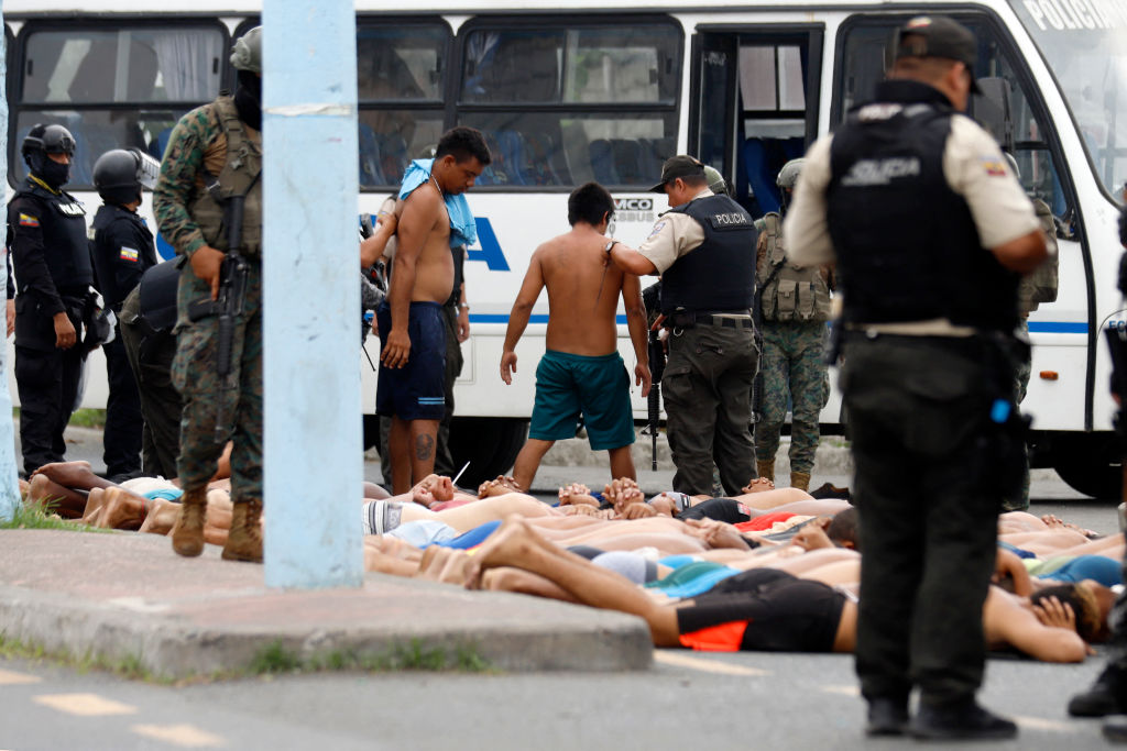 Police keep watch over arrested men who attempted to take over a hospital in Guayas, Ecuador, on January 21, 2024. (Photo by STRINGER / AFP) (Photo by STRINGER/AFP via Getty Images)