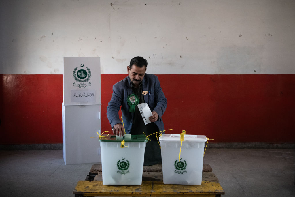 A Pakistani voter casts their ballot during polling for Pakistan's general election at a polling station on February 8, 2024, in Wahgrian, Pakistan. (Photo by Rebecca Conway/Getty Images)