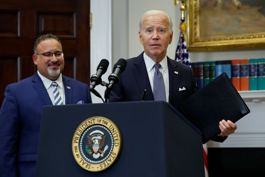 President Joe Biden is joined by Education Secretary Miguel Cardona as he announces new actions to protect borrowers on June 30, 2023, in the White House Roosevelt Room after the Supreme Court struck down his student loan forgiveness plan. (Photo by Chip Somodevilla/Getty Images)