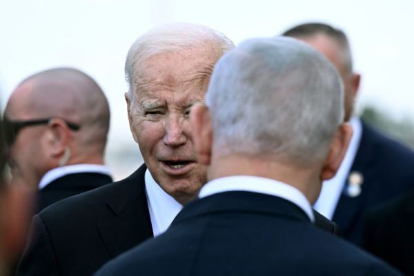 Israeli Prime Minister Benjamin Netanyahu greets President Joe Biden upon his arrival at Tel Aviv's Ben Gurion airport on October 18, 2023. (Photo by Brendan Smialowski / AFP) (Photo by BRENDAN SMIALOWSKI/AFP via Getty Images)