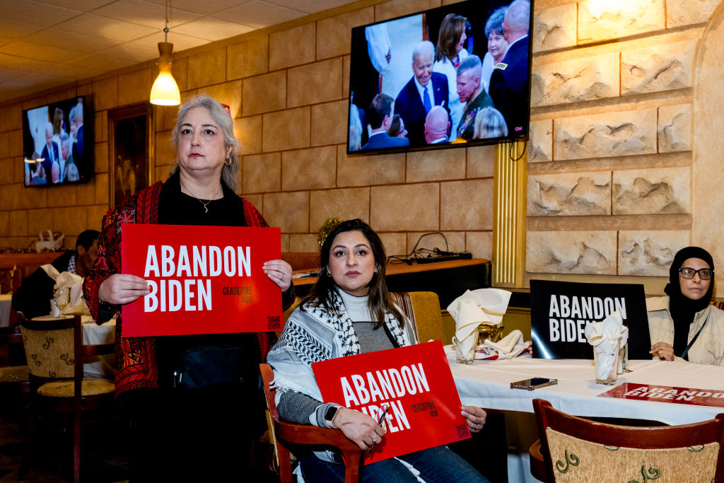 From left, Zarina Malik of Rochester Hills, Farah Khan of Northville, and Latifa Jamel of Dearborn Heights watch President Joe Biden make his introduction during a State of the Union watch party at Adonis in Dearborn, Michigan on March 7, 2024. (Photo by Nic Antaya for The Washington Post via Getty Images)