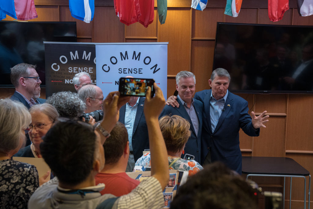 Sen. Joe Manchin and former Utah Gov. Jon Huntsman talk to a crowd after headlining the "Common Sense" Town Hall, an event sponsored by No Labels, on July 17, 2023, at St. Anselm College in Manchester, New Hampshire. (Photo by John Tully for The Washington Post via Getty Images)