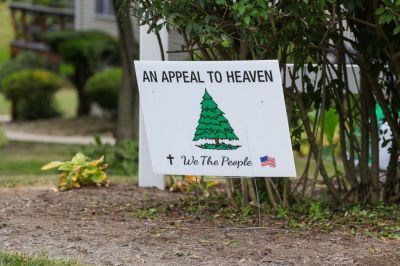 A yard sign is seen with imagery from the “An Appeal to