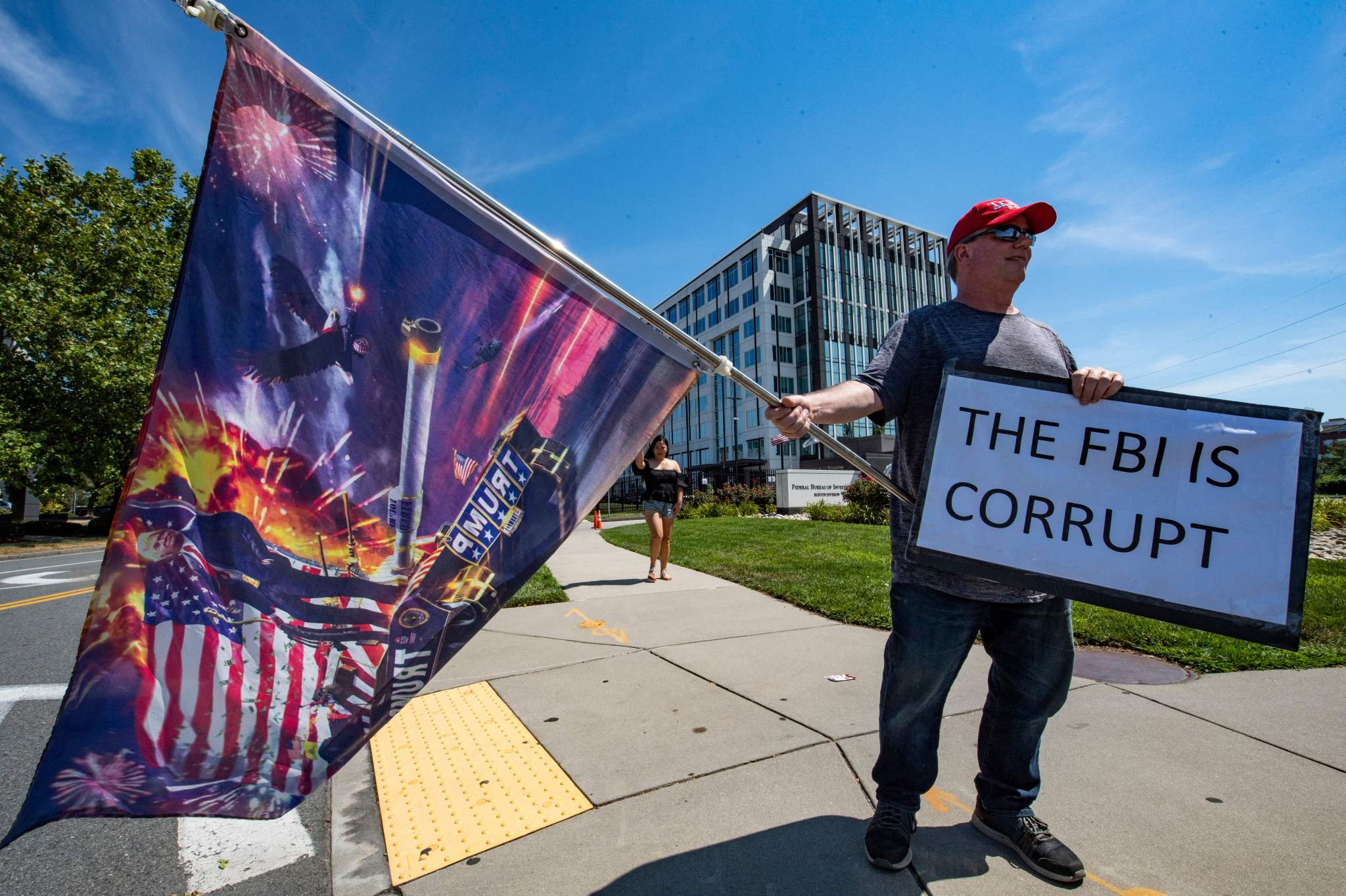 Demonstrators protest the recent actions of the FBI at their Boston headquarters in Chelsea, Massachusetts, on August 21, 2022. (Photo by JOSEPH PREZIOSO/AFP via Getty Images)