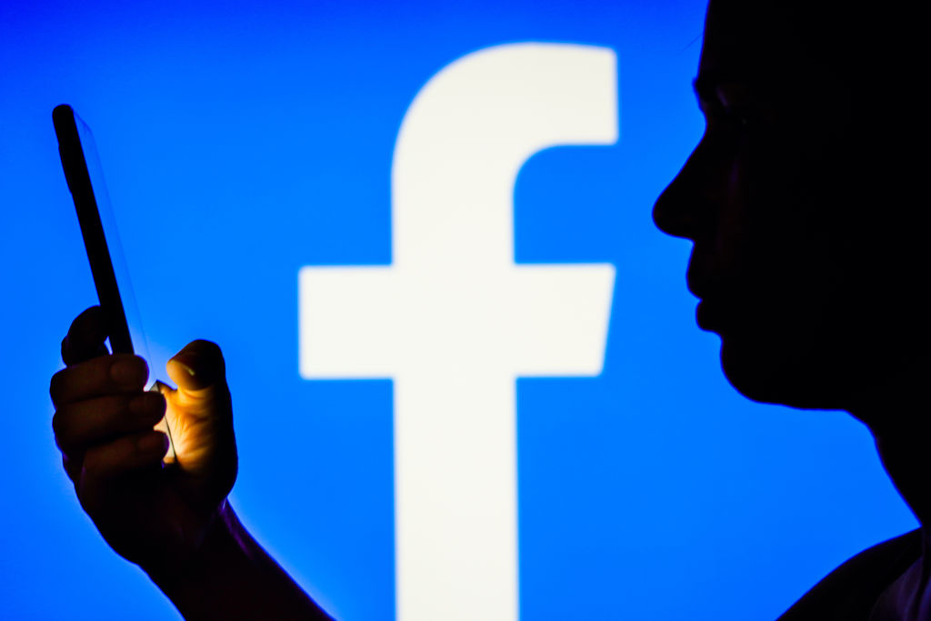 In this photo illustration, a woman’s silhouette holds a
