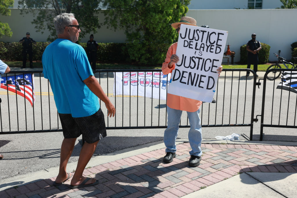 Supporters and protesters of former President Donald Trump stand outside the Alto Lee Adams Sr. Courthouse in Fort Pierce, Florida, on March 14, 2024. (Photo by Joe Raedle/Getty Images)
