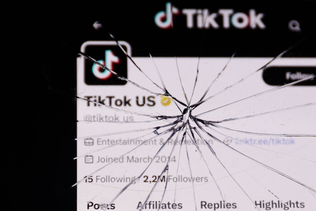 TikTok U.S. account on X displayed on a phone screen is seen through the broken glass in this illustration photo taken in Krakow, Poland on April 24, 2024. (Photo by Jakub Porzycki/NurPhoto via Getty Images)