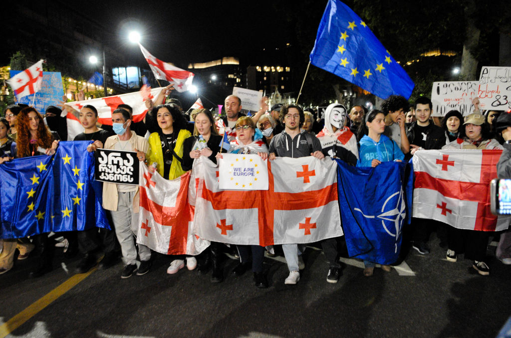 Demonstrators hold European and Georgian flags during a rally in Tbilisi, Georgia, on May 3, 2024, against the parliament's reintroduced "Foreign Agent Bill." (Photo by Nicolo Vincenzo Malvestuto/Getty Images)