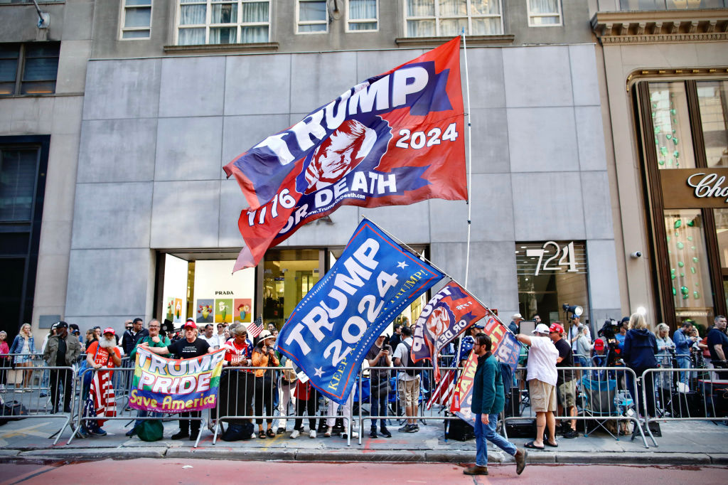 Supporters raise Trump-themed flags across the street from Trump Tower before the former president and Republican presidential candidate holds a press conference  on May 31, 2024. (Photo by KENA BETANCUR/AFP via Getty Images)