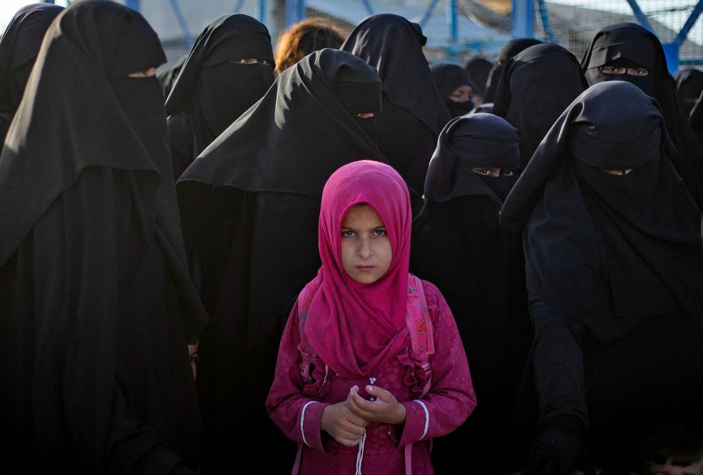 A young girl is photographed in the Kurdish-run al-Hol camp, which holds relatives of suspected Islamic State group fighters, during a security operation by the Kurdish Asayish security forces on August 26, 2022. (Photo by Delil SOULEIMAN / AFP) (Photo by DELIL SOULEIMAN/AFP via Getty Images)