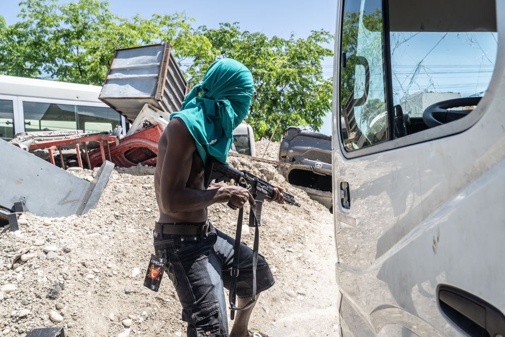 ​An armed gang member at the heavily fortified road barricades in the downtown Delmas 6 area in Port-au-Prince on May 9, 2024. (Photo by Giles Clarke/Getty Images)