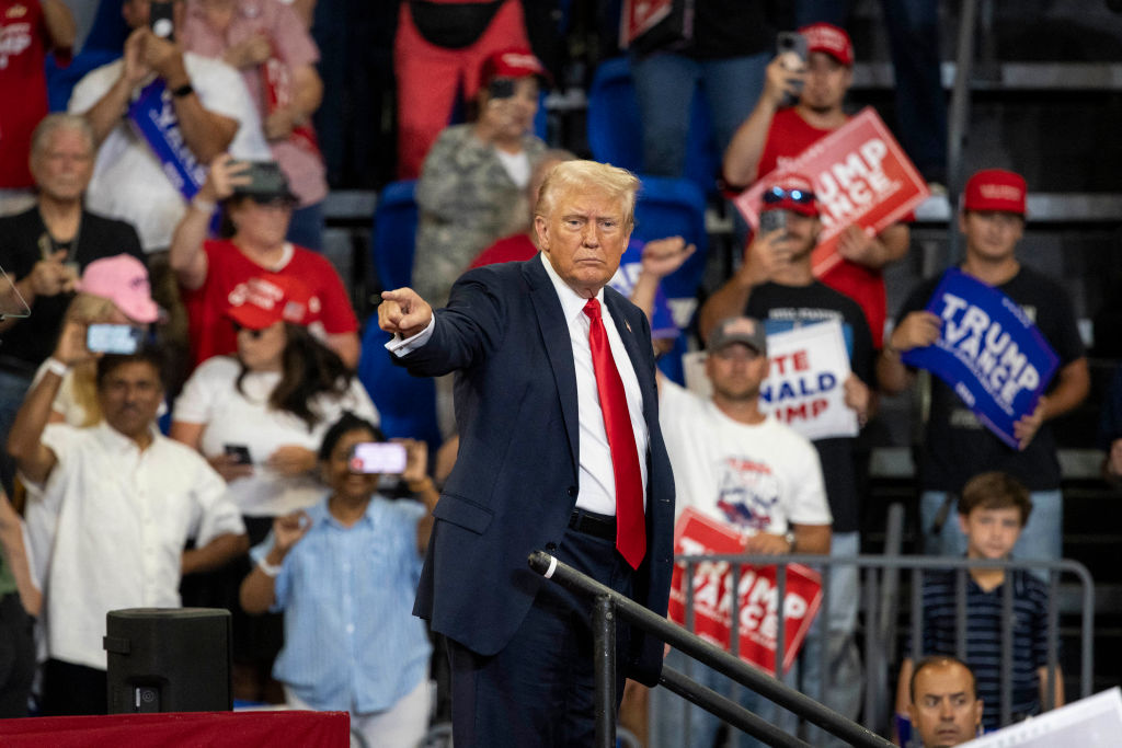 Former President Donald Trump points to the crowd as he leaves after speaking during a campaign rally at the Georgia State University Convocation Center in Atlanta, Georgia, on August 3, 2024. (Photo by CHRISTIAN MONTERROSA/AFP via Getty Images)