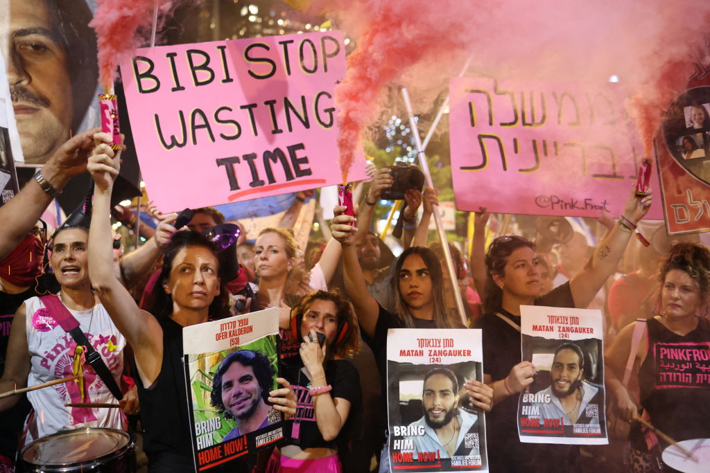 Relatives and supporters of Israelis held hostage by militants in Gaza since the October 7 attacks hold placards as they demonstrate calling for their release in Tel Aviv on August 10, 2024. (Photo by OREN ZIV/AFP via Getty Images)