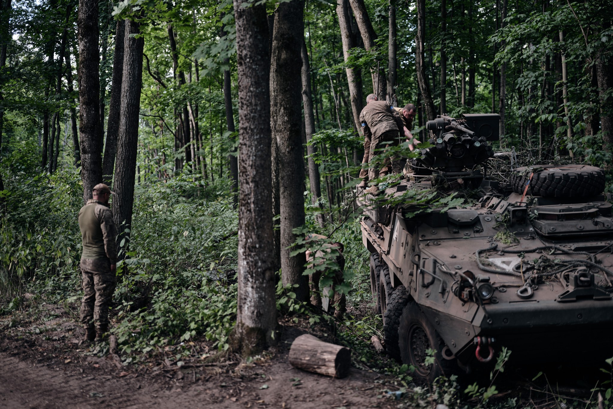 A Ukrainian mechanic returns from a combat mission in the Kursk Region and examines an American Stryker armored vehicle on August 14, 2024, near the Russian border in the Sumy region of Ukraine. (Photo by Kostiantyn Liberov/Libkos/Getty Images)