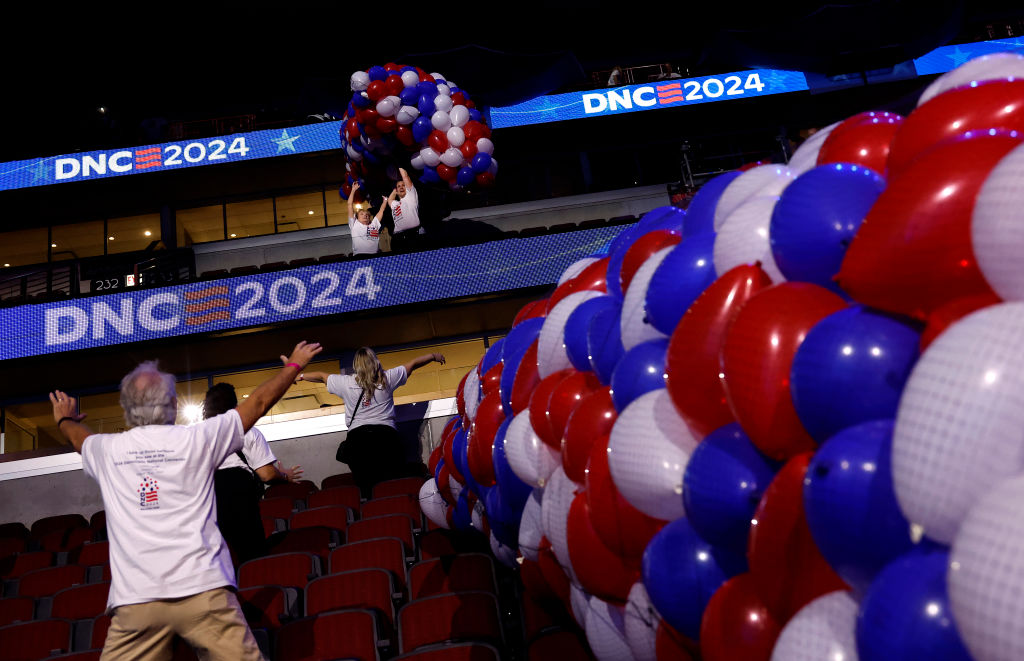 Workers set up balloons in the United Center for the Democratic National Convention on August 16, 2024, in Chicago. (Photo by Kevin Dietsch/Getty Images)