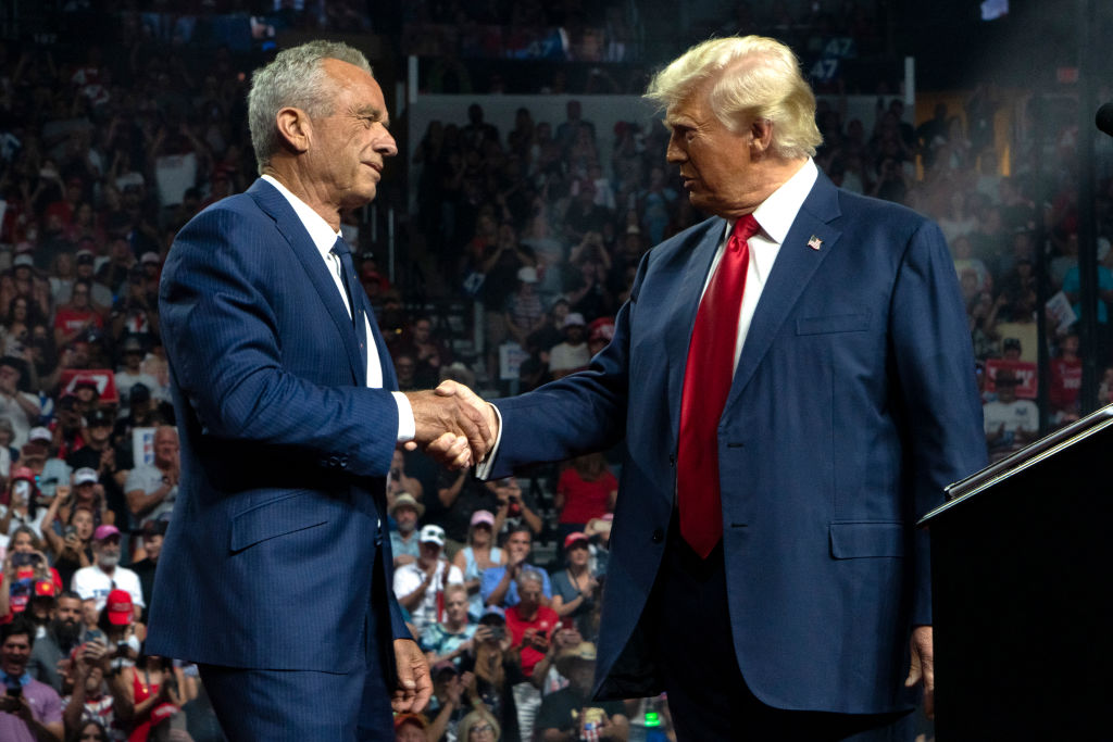 Former presidential candidate Robert F. Kennedy Jr. and the Republican presidential nominee, former U.S. President Donald Trump, shake hands during a campaign rally at Desert Diamond Arena on August 23, 2024, in Glendale, Arizona. (Photo by Rebecca Noble/Getty Images)