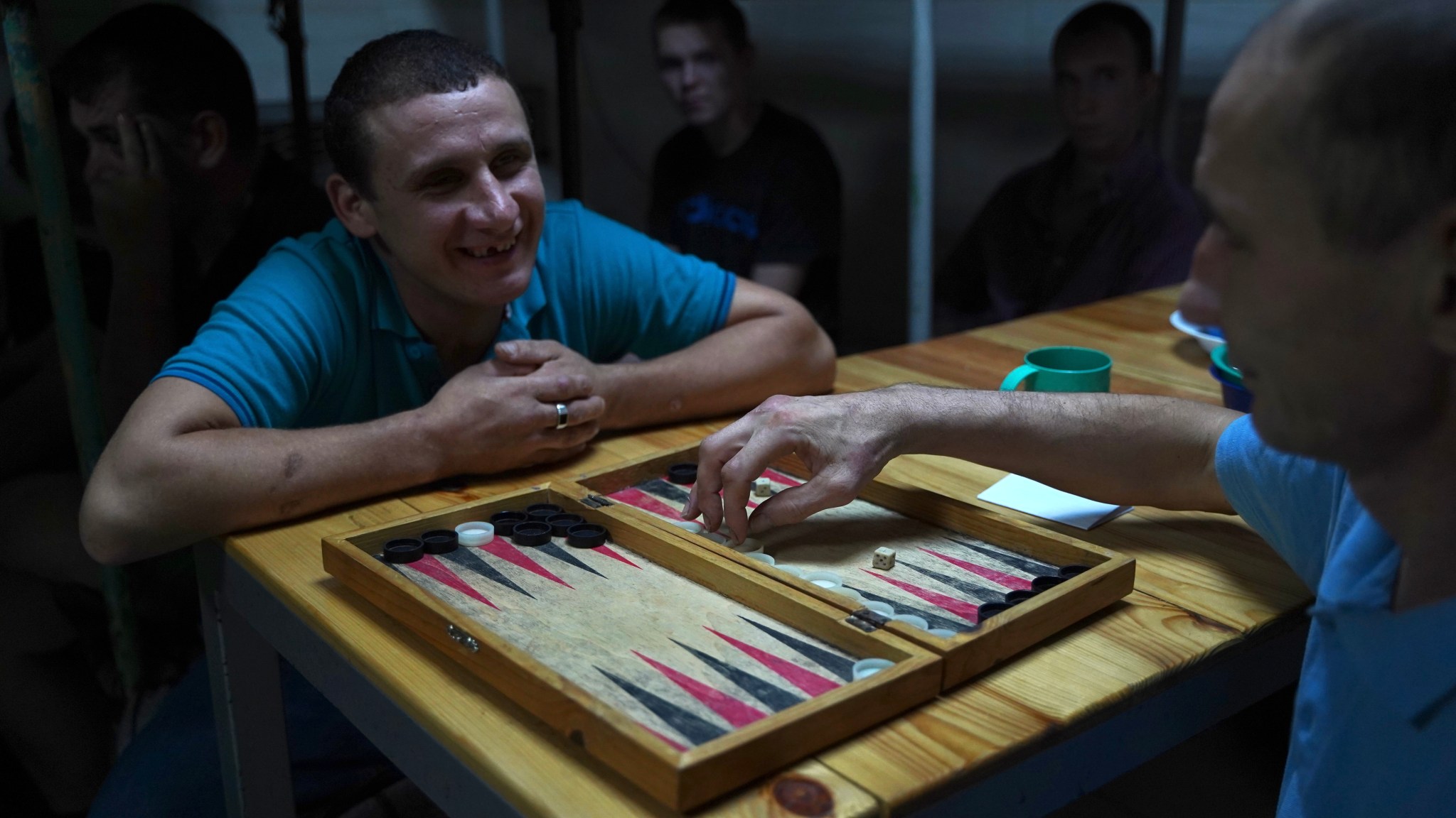 Russian prisoners of war play backgammon after lunch. They were captured by the Ukrainian army during the Kursk offensive in August. (Photograph by Iryna Matviyishyn) 